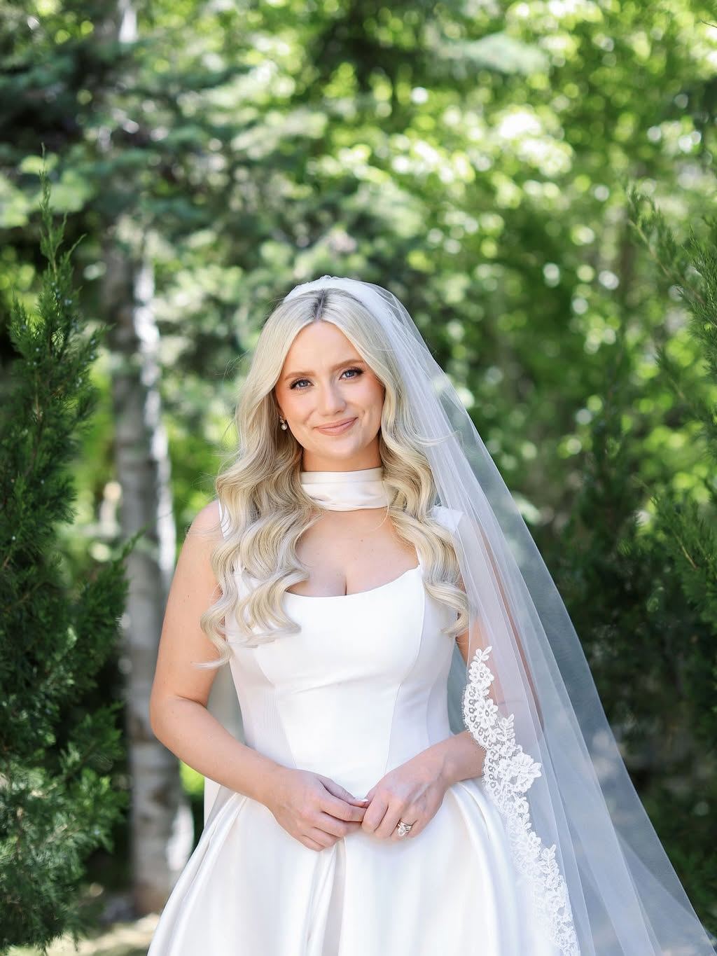 Utah bride with soft glam waves and a lace-edged cathedral veil, styled by Laura Loves Hair